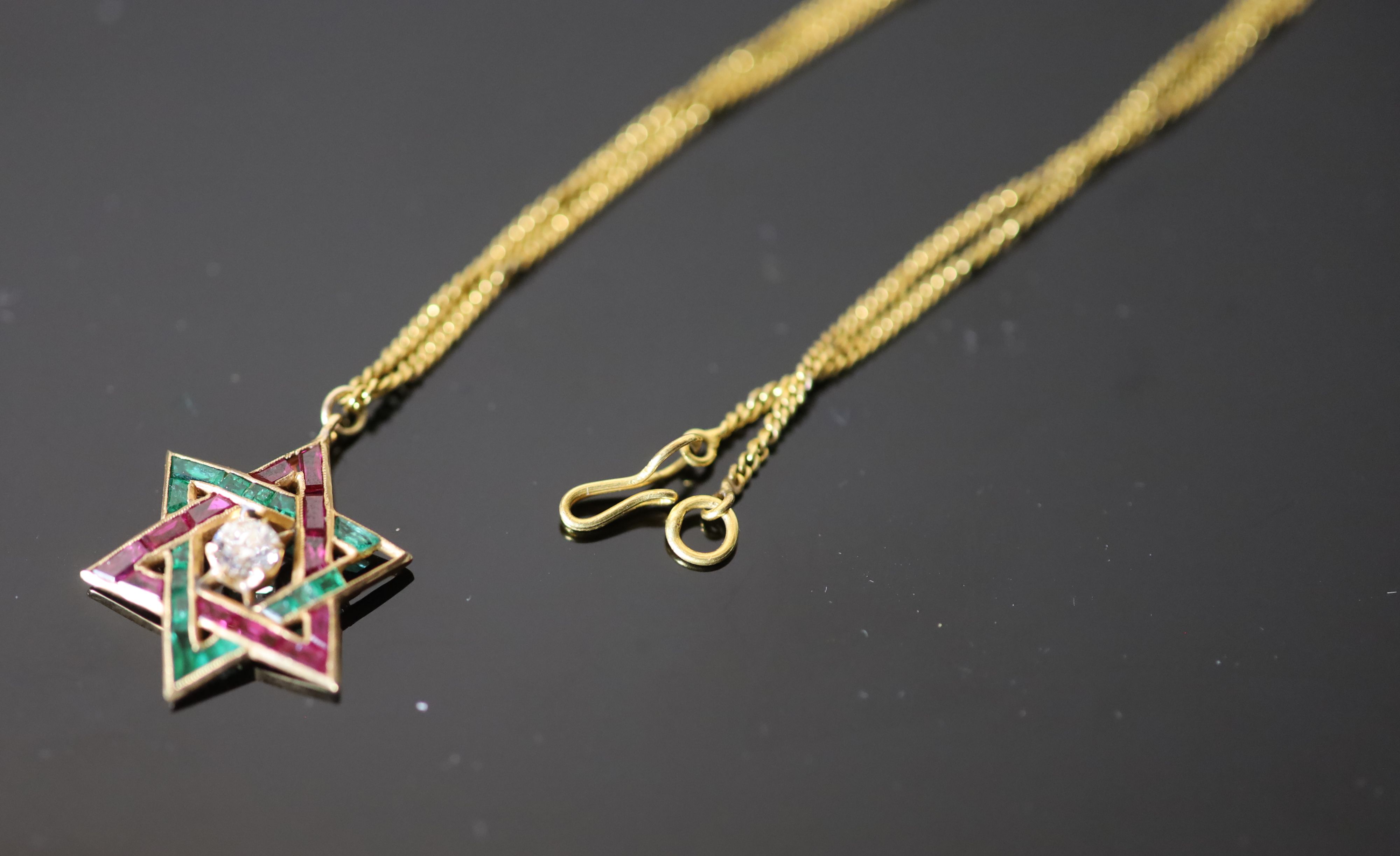 A continental gold, emerald, ruby and diamond set Star of David pendant, on a gold fine link chain,